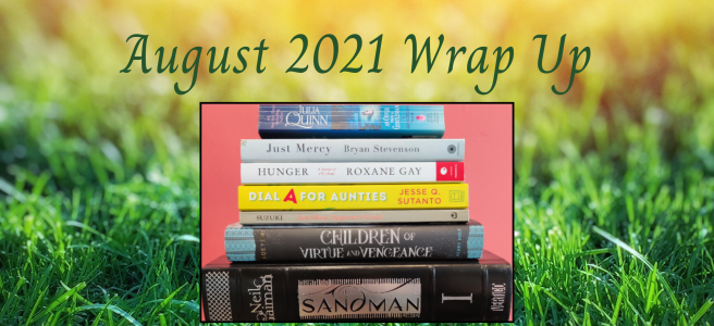 The background features fresh green grass and sunlight coming from the top. The title of the post is at the top in green writing "August 2021 Wrap Up". A stack of books that were read is featured in the middle.